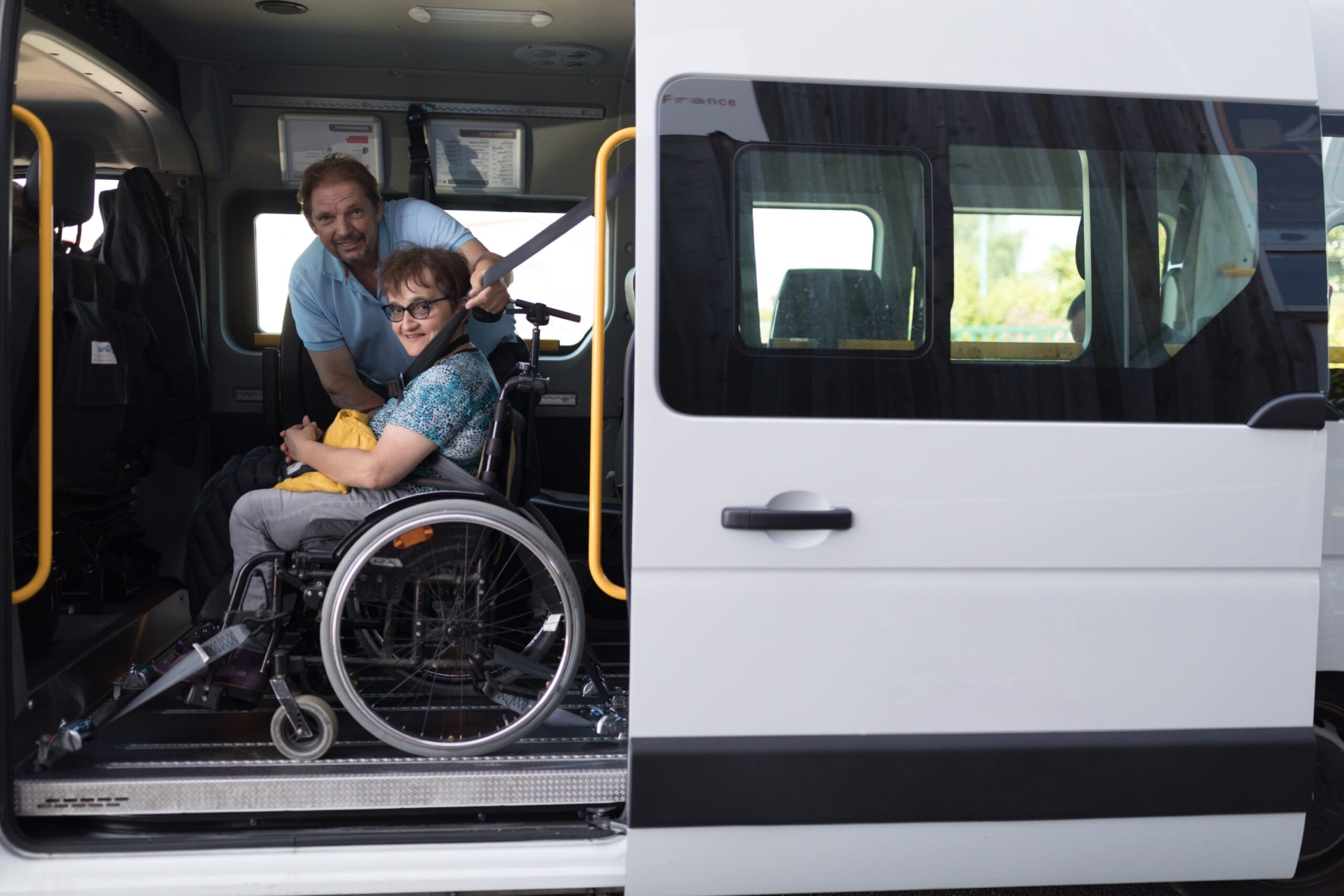 a woman in a wheelchair in a car